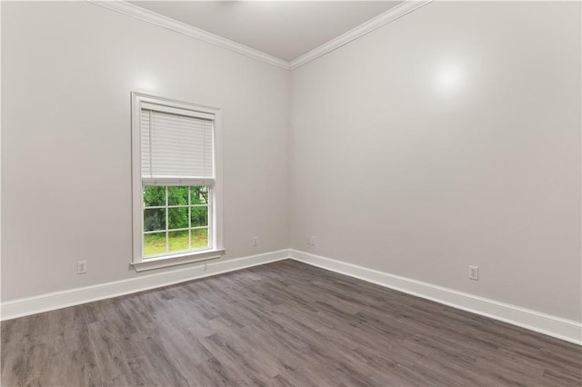 empty room with ornamental molding, dark wood-style flooring, and baseboards