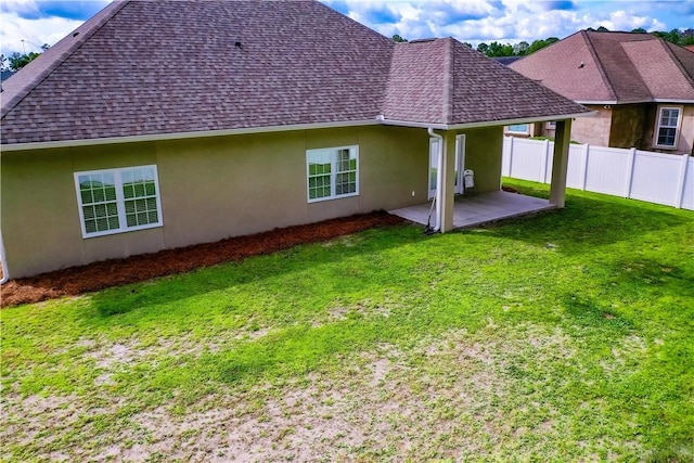 550 Freedom Trl, Brunswick, GA 31525 - back of house featuring a lawn and a patio