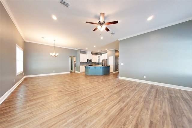 550 Freedom Trl, Brunswick, GA 31525 - unfurnished living room featuring ceiling fan with notable chandelier, light hardwood / wood-style flooring, and crown molding