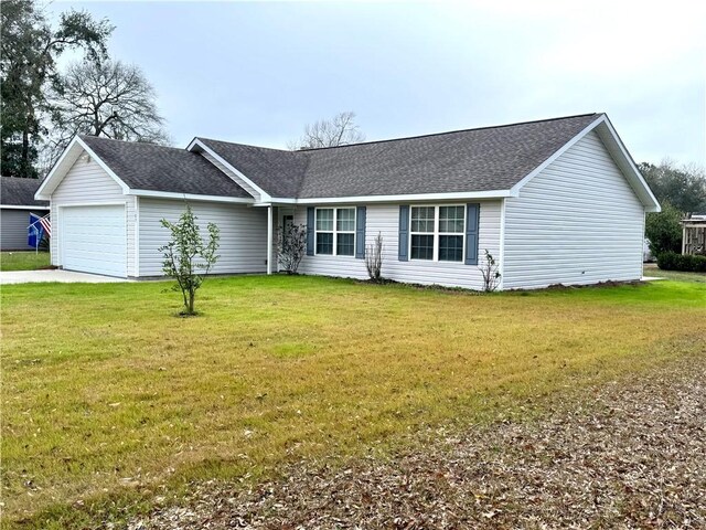 single story home featuring a garage and a front lawn