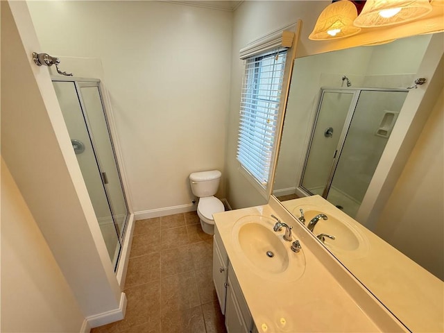 bathroom with tile patterned flooring, vanity, toilet, and a shower with shower door