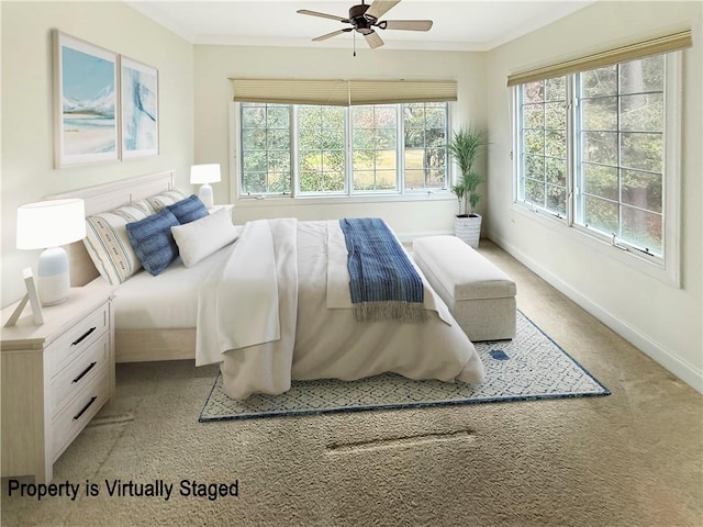 bedroom featuring crown molding, light colored carpet, baseboards, and ceiling fan