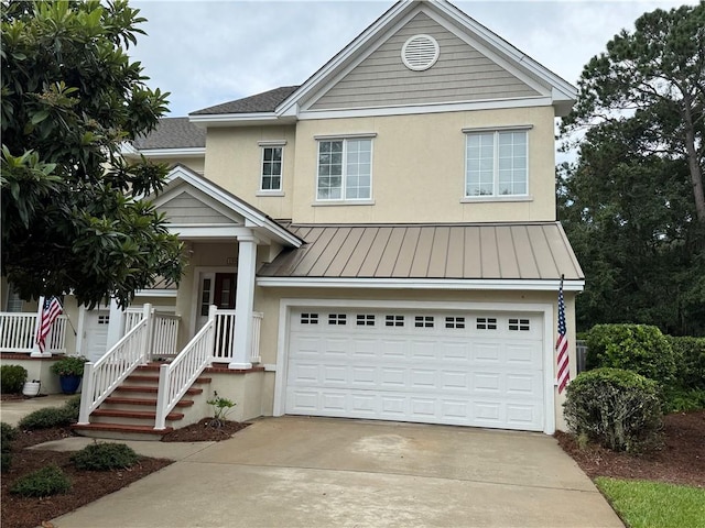 traditional-style home with a garage, stucco siding, concrete driveway, and a standing seam roof