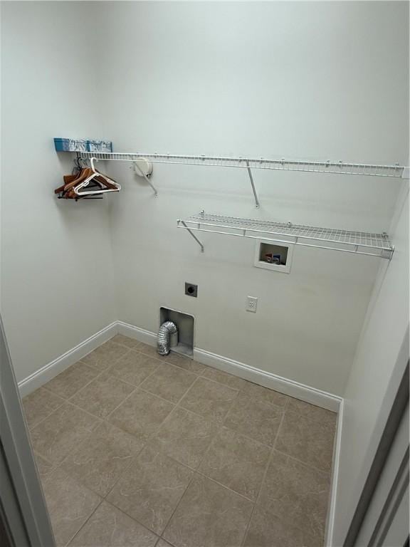 clothes washing area featuring hookup for an electric dryer, washer hookup, and light tile patterned floors