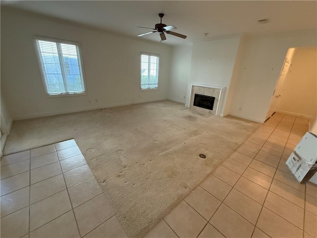 unfurnished living room with ceiling fan and light tile patterned floors