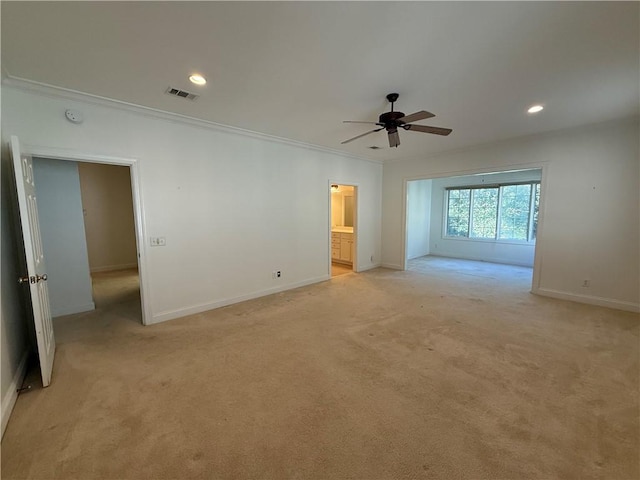 unfurnished room with ceiling fan, ornamental molding, and light carpet