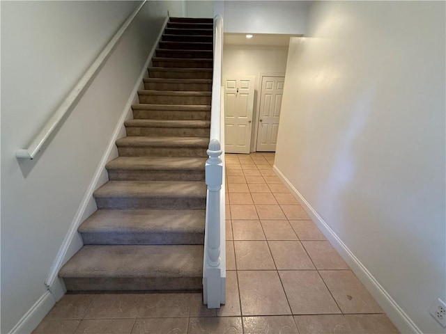 stairs with tile patterned floors