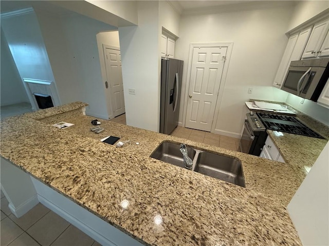 kitchen with kitchen peninsula, stainless steel appliances, and white cabinetry