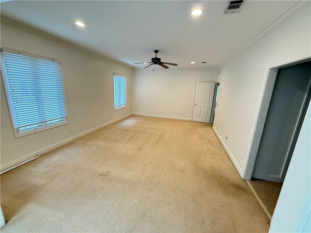 unfurnished room featuring light carpet, crown molding, and ceiling fan