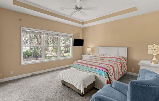 704 Dungeness, Saint Simons Island, GA 31522 - carpeted bedroom with a tray ceiling, ornamental molding, and a ceiling fan