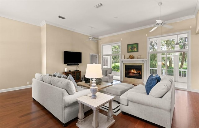 704 Dungeness, Saint Simons Island, GA 31522 - living room with ceiling fan, ornamental molding, a lit fireplace, and dark wood-style floors