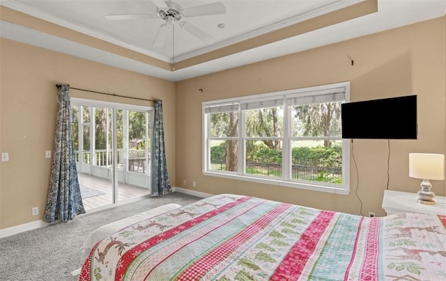 704 Dungeness, Saint Simons Island, GA 31522 - bedroom with access to exterior, carpet flooring, ornamental molding, a tray ceiling, and a ceiling fan