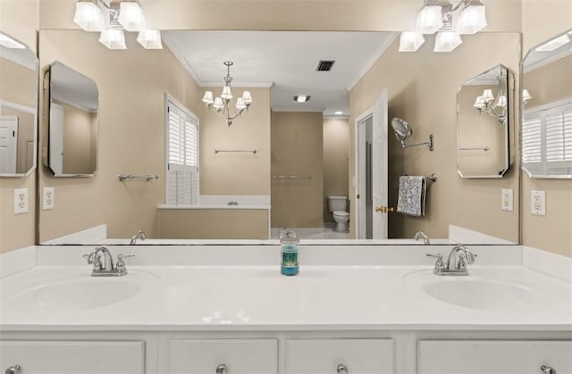 704 Dungeness, Saint Simons Island, GA 31522 - bathroom featuring a chandelier, ornamental molding, and double vanity