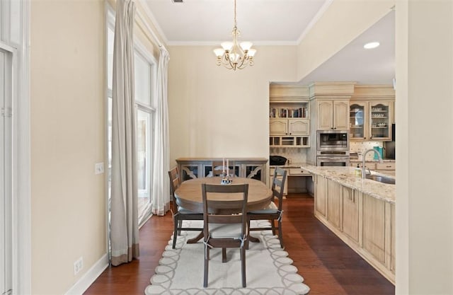 704 Dungeness, Saint Simons Island, GA 31522 - dining room with healthy amount of natural light, a chandelier, crown molding, and dark wood-style flooring