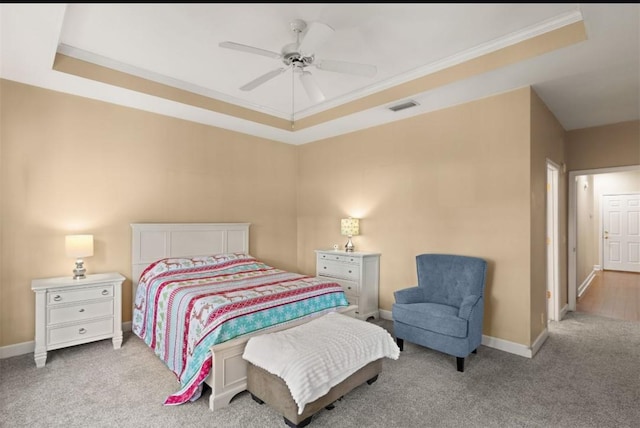 704 Dungeness, Saint Simons Island, GA 31522 - bedroom featuring a tray ceiling, light carpet, crown molding, and ceiling fan