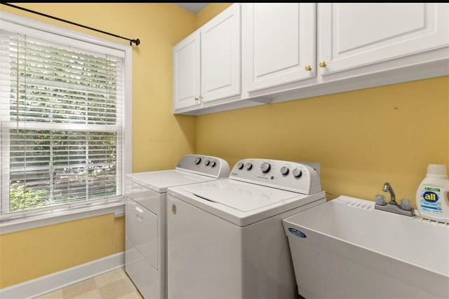 704 Dungeness, Saint Simons Island, GA 31522 - washroom with washer and clothes dryer and cabinet space