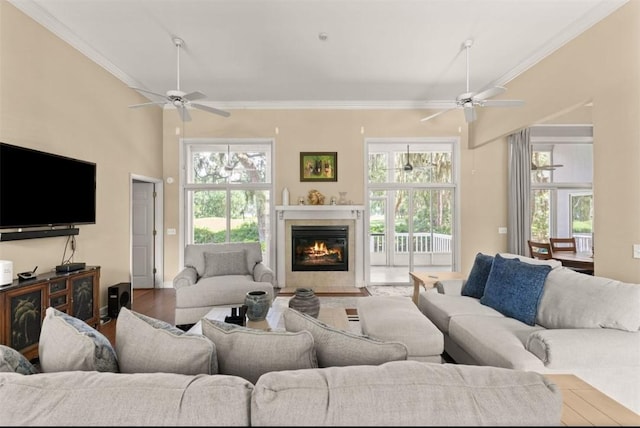 704 Dungeness, Saint Simons Island, GA 31522 - living area with ceiling fan, crown molding, a tiled fireplace, and wood finished floors