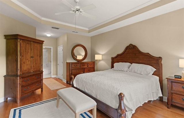 704 Dungeness, Saint Simons Island, GA 31522 - bedroom with light wood-style flooring, crown molding, ceiling fan, and ensuite bathroom