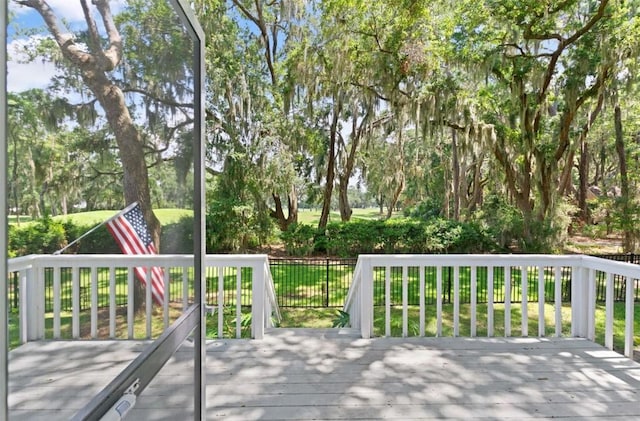 704 Dungeness, Saint Simons Island, GA 31522 - deck featuring view of wooded area