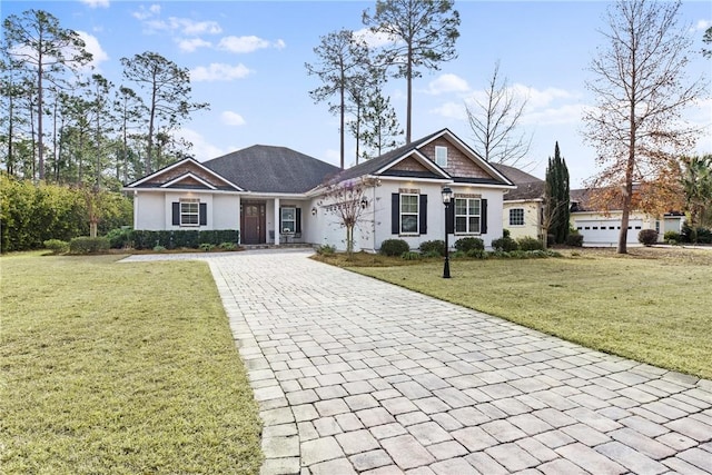 view of front of home with a garage and a front yard