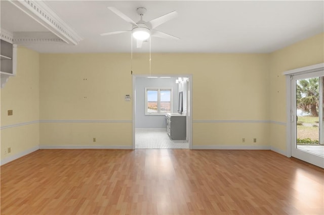 empty room featuring ceiling fan and light hardwood / wood-style flooring