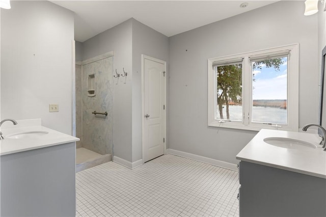 bathroom with a shower, vanity, and a water view