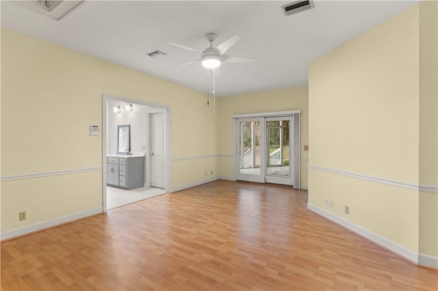 unfurnished room with ceiling fan and light wood-type flooring