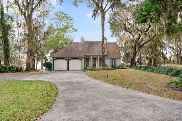 view of front of property featuring a garage and a front lawn