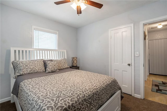 carpeted bedroom with a ceiling fan and baseboards