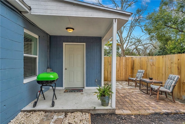 doorway to property with a patio area and fence