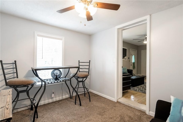 interior space featuring carpet floors, baseboards, and a ceiling fan