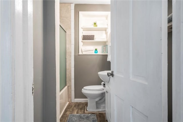 bathroom with toilet, shower / bath combination with glass door, and wood finished floors