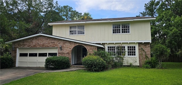 140 Belle Point Pkwy, Brunswick, GA 31525 - view of front facade with brick siding, concrete driveway, an attached garage, a front yard, and board and batten siding