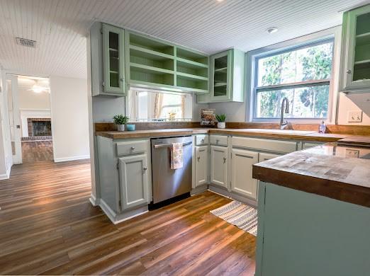 140 Belle Point Pkwy, Brunswick, GA 31525 - kitchen with dishwasher, dark wood-style flooring, glass insert cabinets, a brick fireplace, and wood ceiling