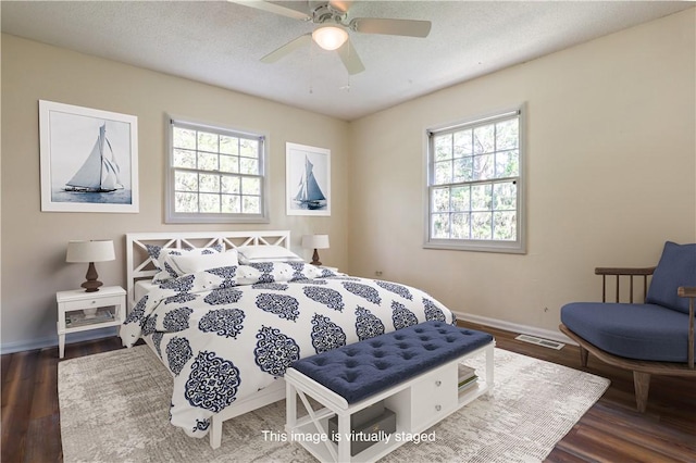 140 Belle Point Pkwy, Brunswick, GA 31525 - bedroom featuring multiple windows, wood finished floors, and a ceiling fan