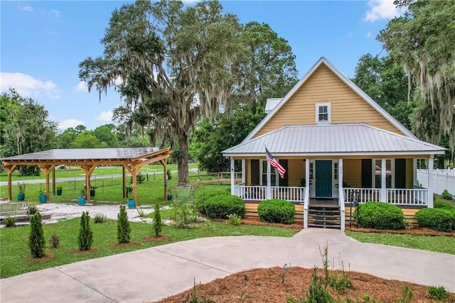 800 Wayne St, Darien, GA 31305 - view of front of house featuring covered porch, metal roof, and a front lawn