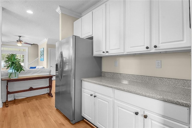 800 Wayne St, Darien, GA 31305 - kitchen with stainless steel fridge, ornamental molding, a textured ceiling, ceiling fan, and white cabinetry