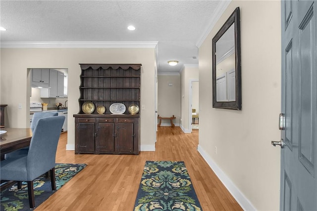 800 Wayne St, Darien, GA 31305 - hall with ornamental molding, light wood-style floors, baseboards, a textured ceiling, and recessed lighting