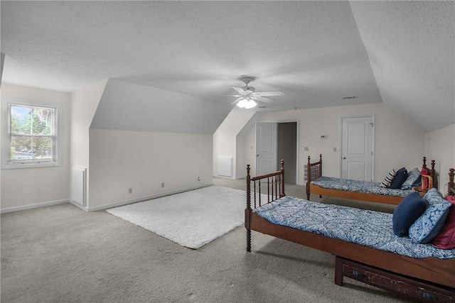 800 Wayne St, Darien, GA 31305 - bedroom with a textured ceiling, carpet floors, baseboards, vaulted ceiling, and a ceiling fan
