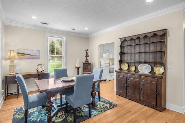 800 Wayne St, Darien, GA 31305 - dining space featuring light wood finished floors, a textured ceiling, ornamental molding, baseboards, and recessed lighting