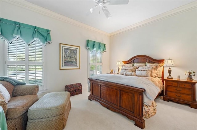 carpeted bedroom featuring ceiling fan and crown molding