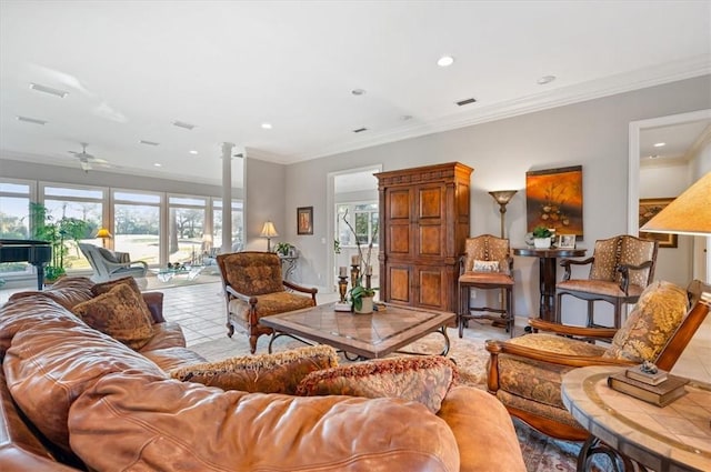 tiled living room with ceiling fan, ornamental molding, a wealth of natural light, and ornate columns