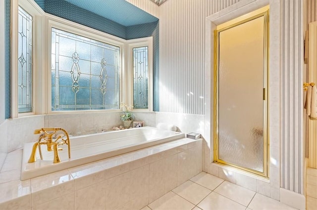 bathroom featuring tile patterned flooring and independent shower and bath