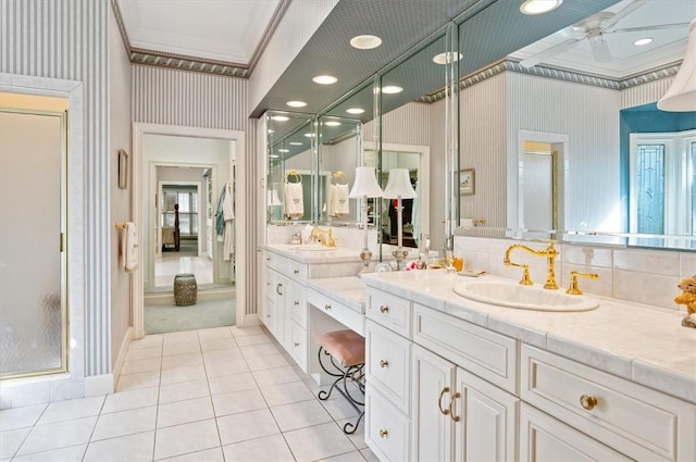 bathroom with ceiling fan, walk in shower, tile patterned flooring, crown molding, and vanity