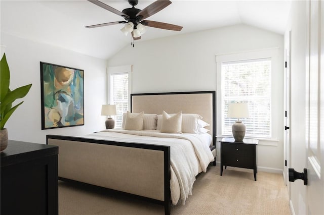 bedroom with lofted ceiling, light carpet, baseboards, and a ceiling fan