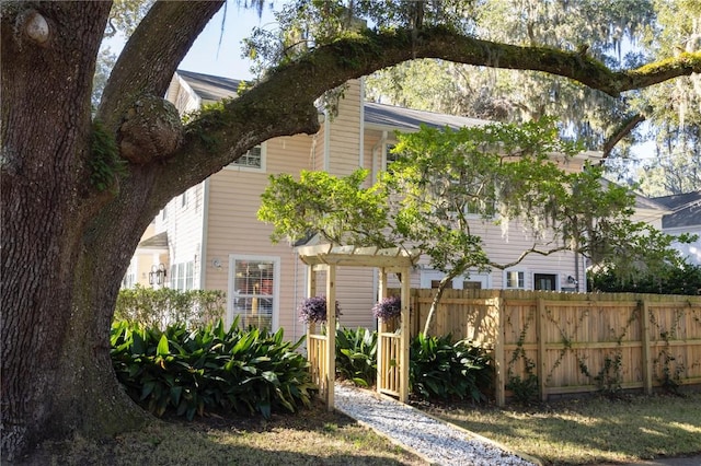 view of front of home featuring fence