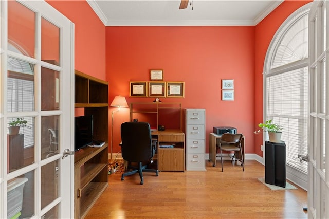 office space with light wood-type flooring, ornamental molding, and french doors