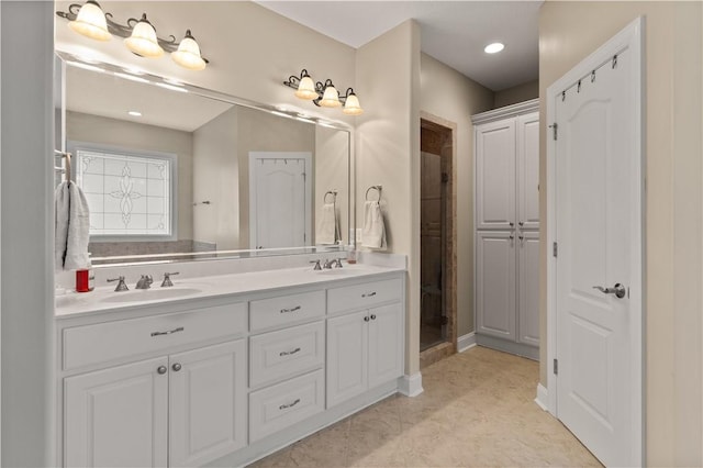 bathroom with vanity and a shower with shower door