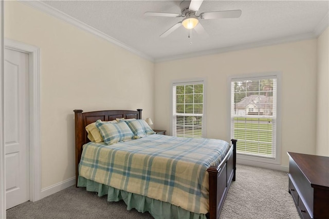 carpeted bedroom with ceiling fan, crown molding, and a textured ceiling