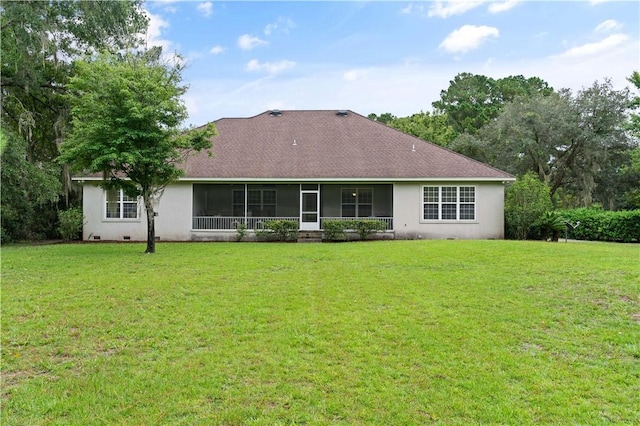 back of house featuring a sunroom and a yard